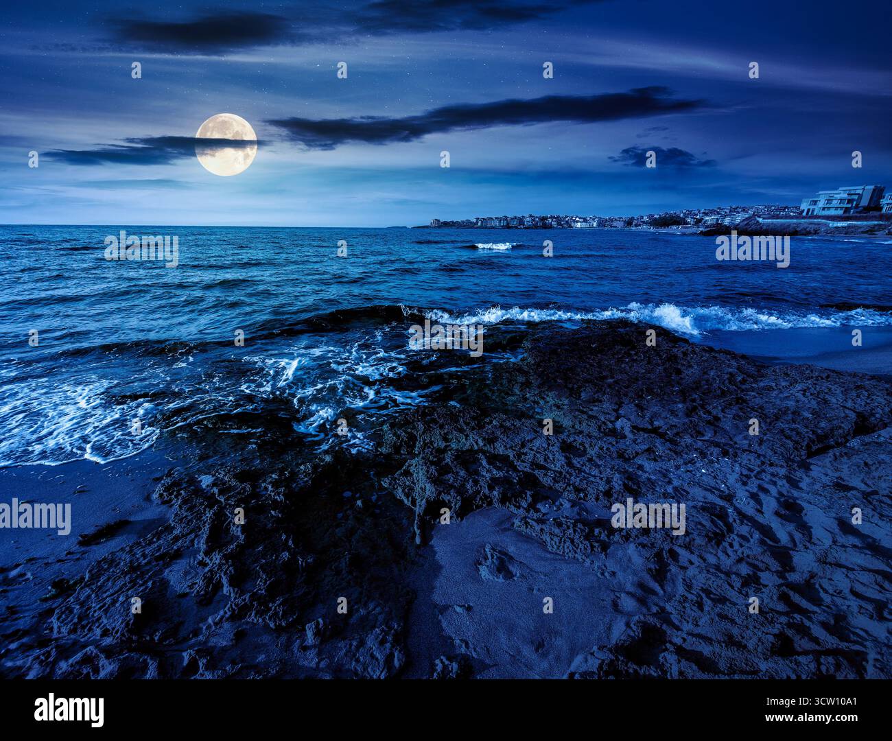 sunrise on a sandy town beach in mellow season at night. beautiful and warm weather on the shores of black sea. coast in full moon light Stock Photo