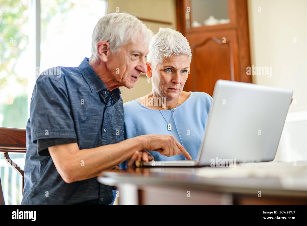 daughter explaining some documentation to senior parent Stock Photo