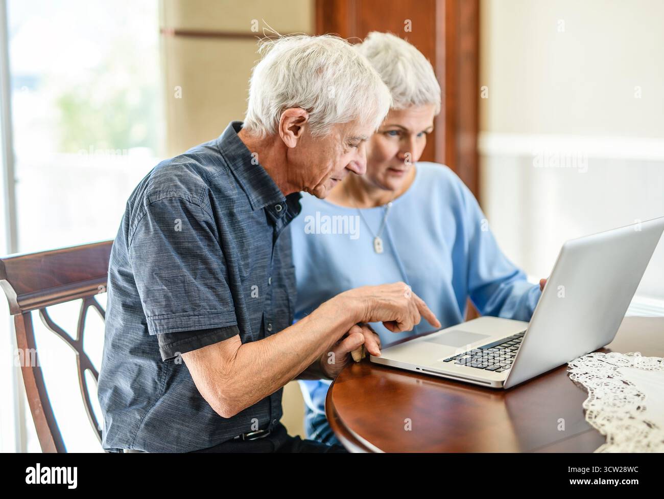 daughter explaining some documentation to senior parent Stock Photo