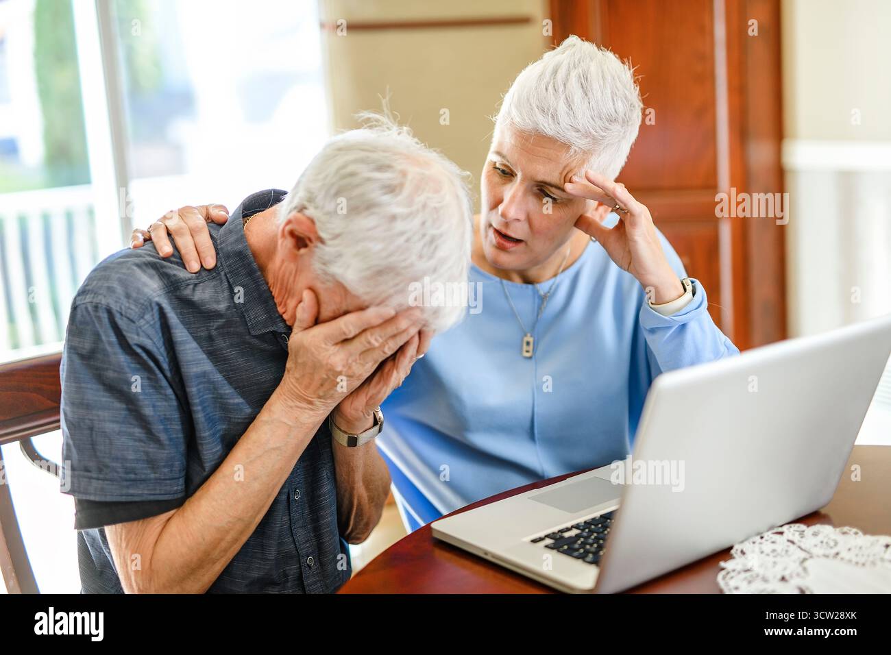 daughter explaining some documentation to senior parent Stock Photo