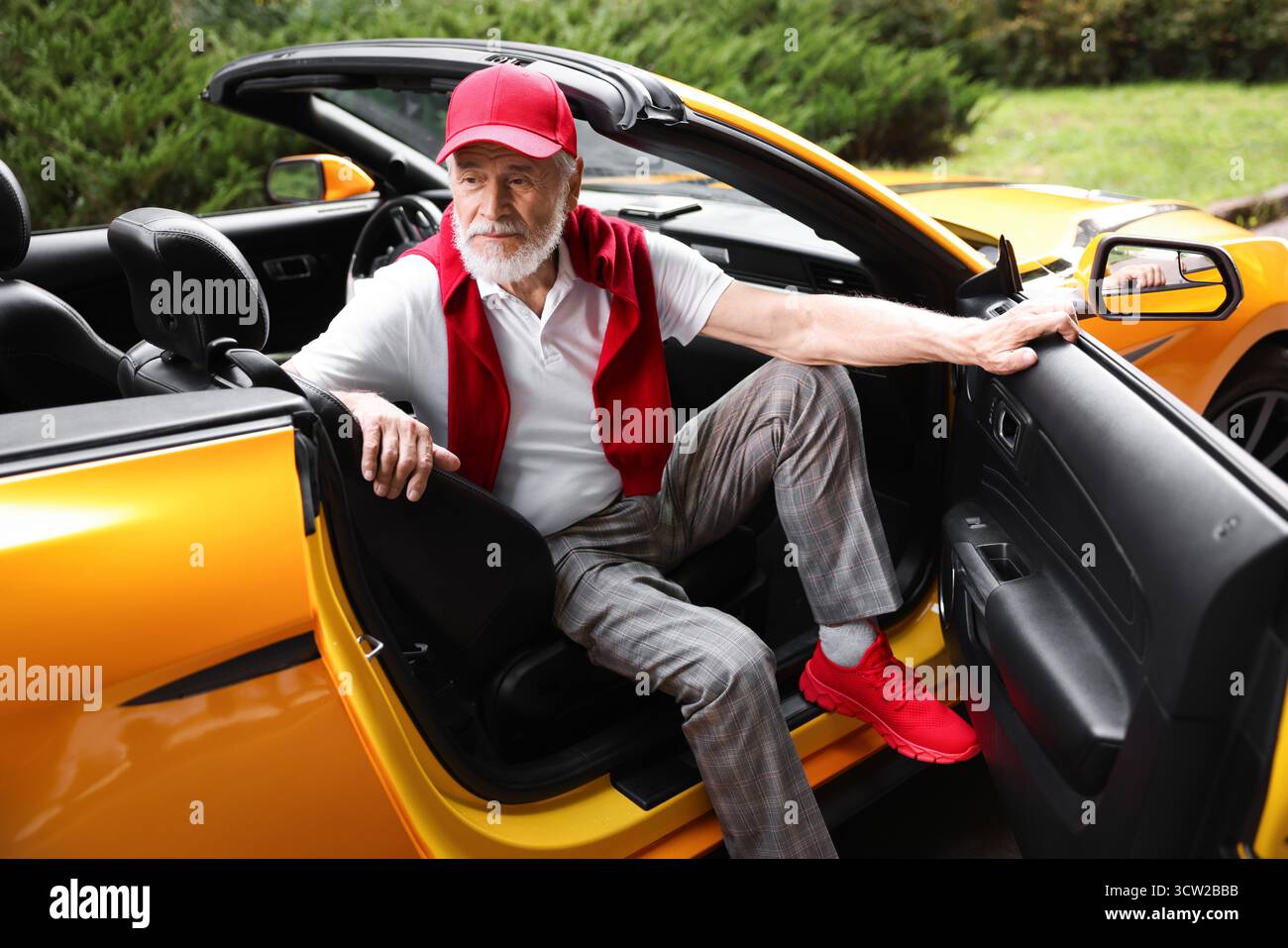 Stylish senior man getting out of modern cabriolet outdoors Stock Photo