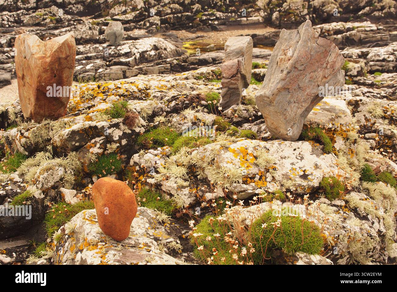Large, balanced stones on a rocky beach on Islay, Inner Hebrides, Scotland UK showing peoples skill in balance art Stock Photo