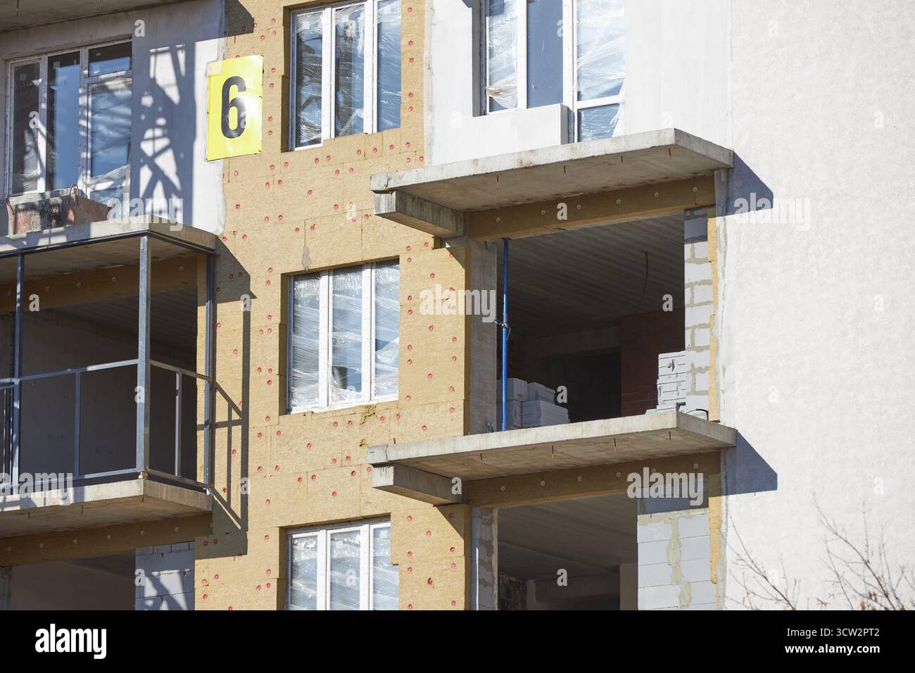 New residential building under construction features exposed walls and ...