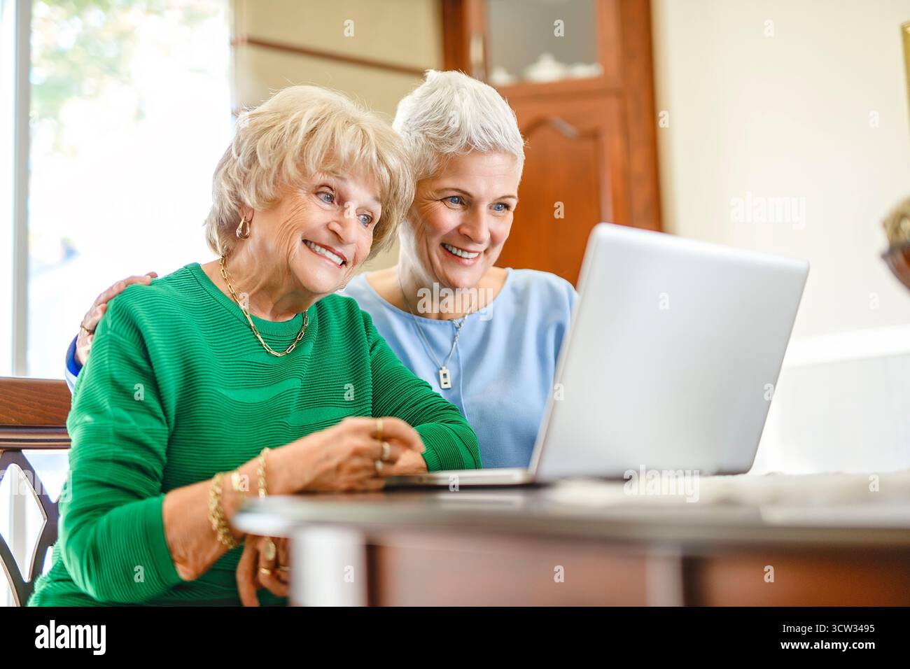 daughter explaining some documentation to senior parent Stock Photo