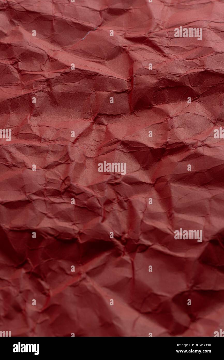 Crumpled red paper as background. Close up Stock Photo