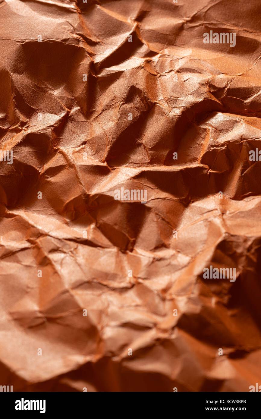 Crumpled orange paper as background. Close up image Stock Photo