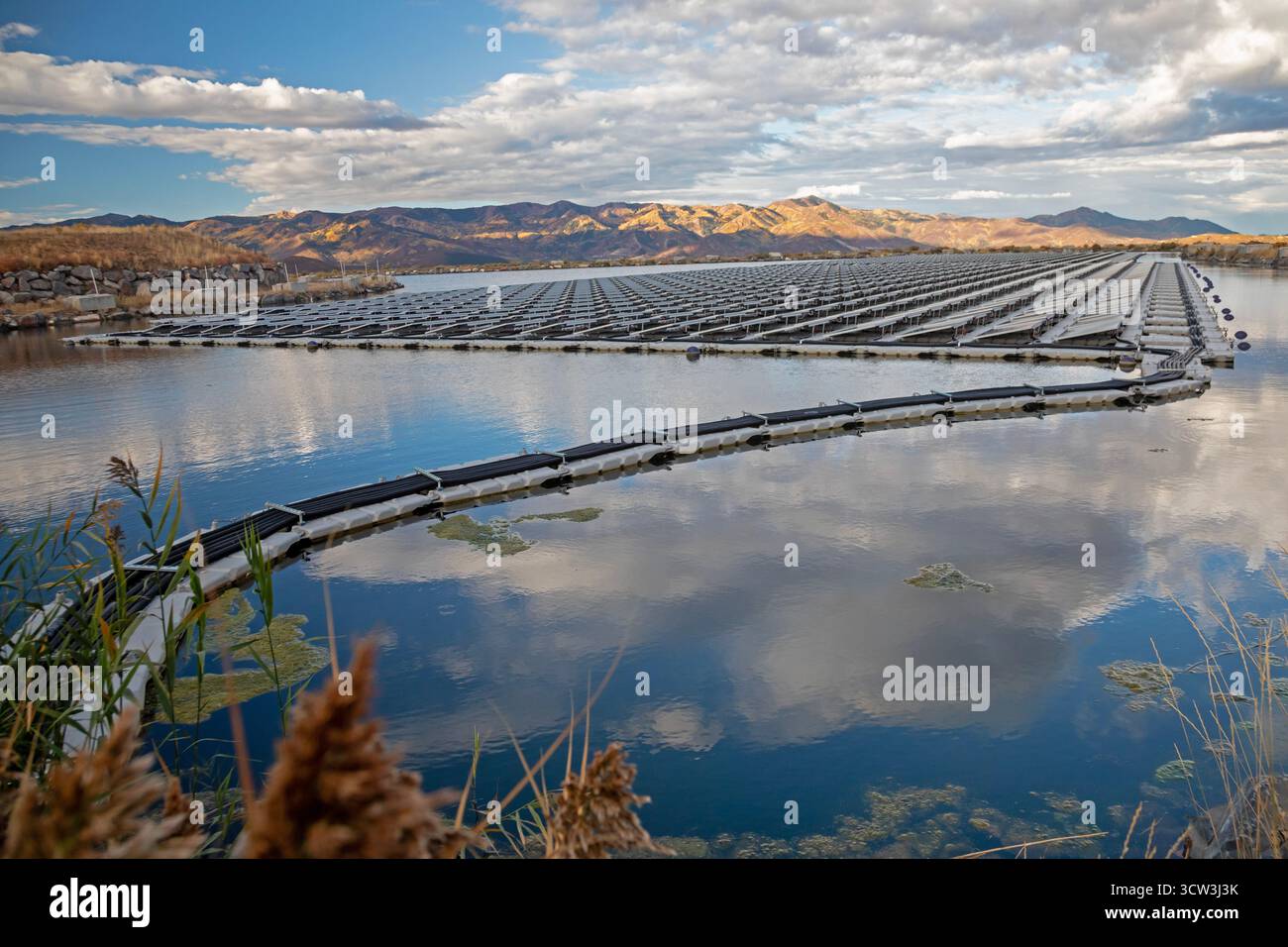Park City, Utah - Floating solar panels provide power for Mountain Regional Water. The solar array is on the raw water storage pond at the water utili Stock Photo