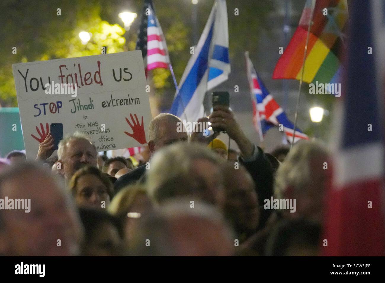 Demonstrators hold placards and flags as they take part in an anti ...