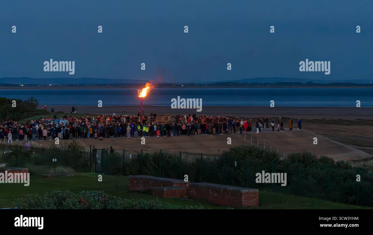 a large crowd gathers on the promenade at fairhaven lake to celebrate lighting the beacon to celebrate the 80th anniversary of VE day Stock Photo