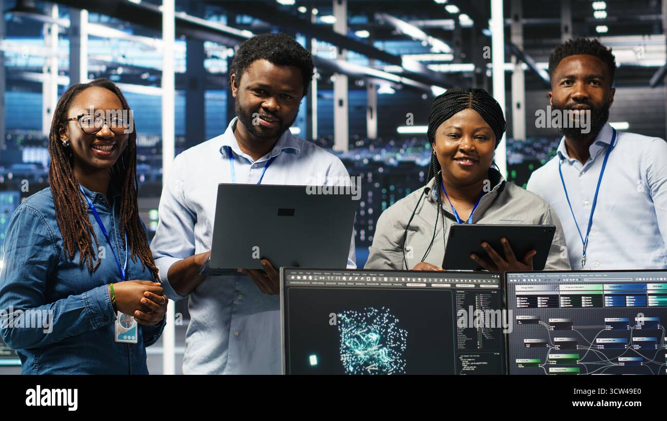 Smiling server hub engineers collaborating, using AI algorithms and node tree systems to categorize unstructured data. Colleagues use visual programming and natural language processing tools, camera B Stock Photo