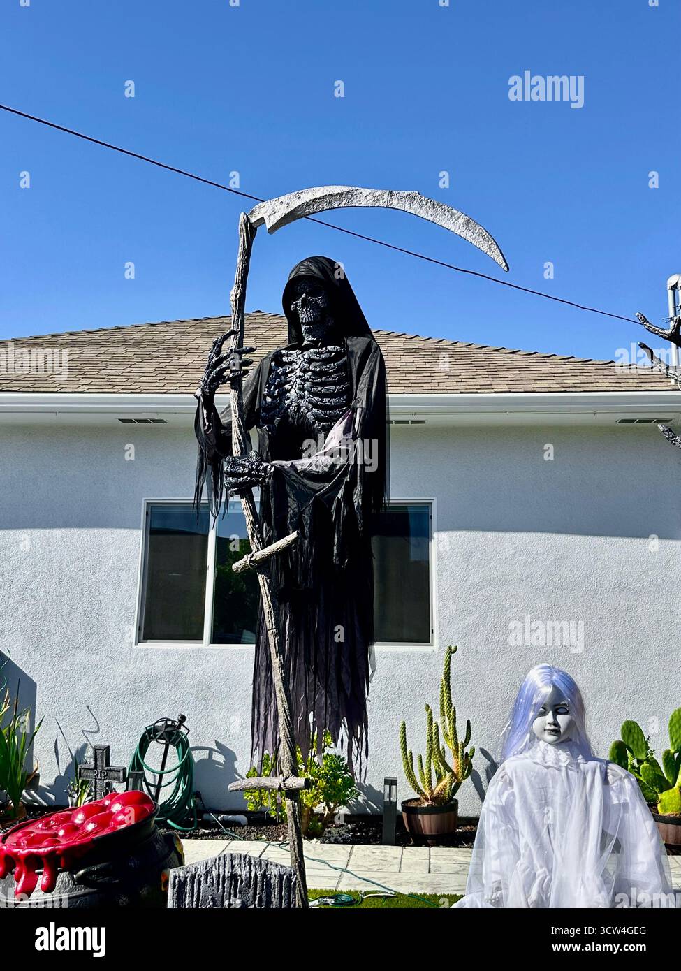 Grim Reaper and Ghost Girl Halloween Display in California - Smartphone Captured Stock Image