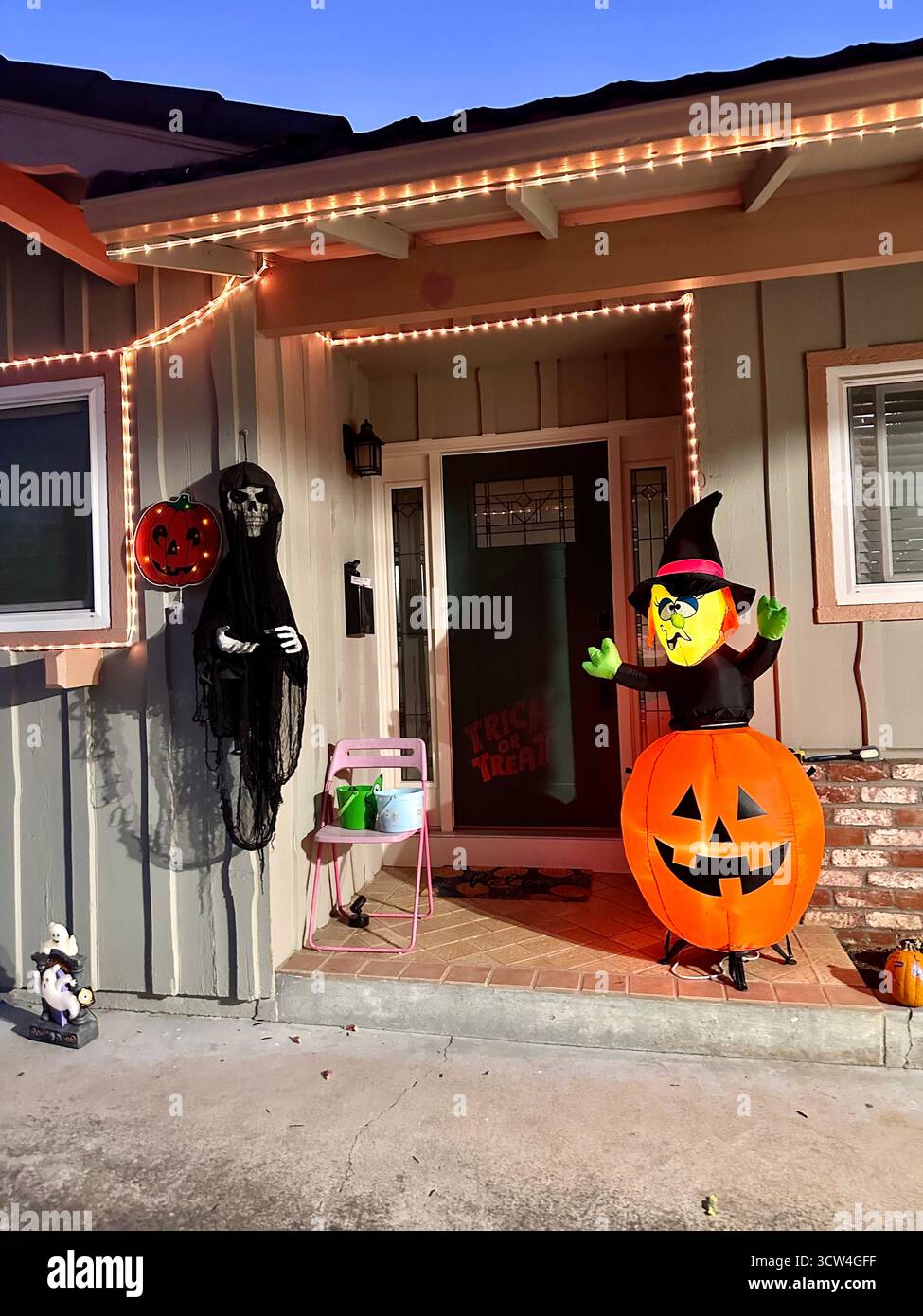 Halloween Porch Decorations with Inflatable Pumpkin and Witch - Smartphone Captured Stock Image