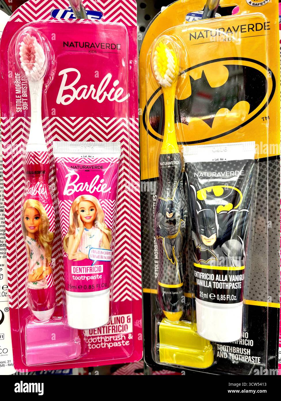 Barbie and Batman branded kids’ toothpaste and toothbrush sets displayed on a retail shelf in Bulgaria - Smartphone Captured Stock Image