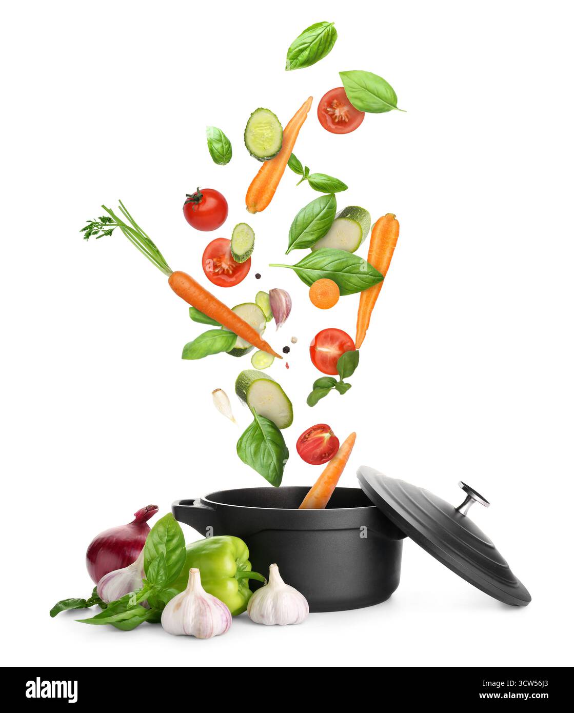 Cooking pot and different flying vegetables on white background Stock Photo
