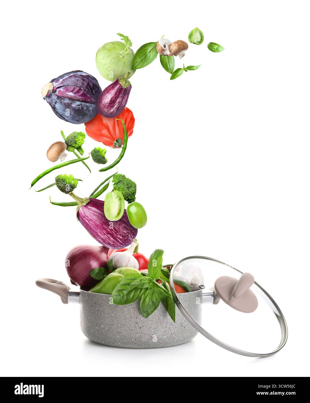 Cooking pot and different flying vegetables on white background Stock Photo