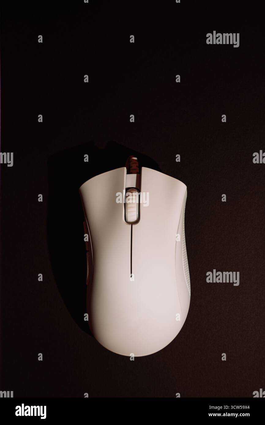 White wired gaming mouse on dark background top view Stock Photo