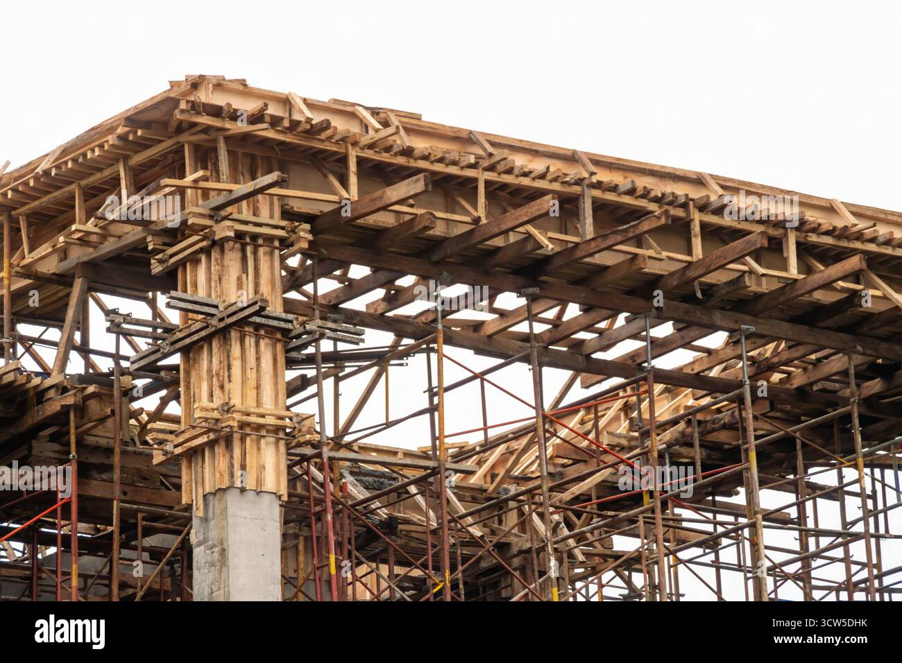Wooden and plywood concrete beam formwork held by metal scaffolding at ...