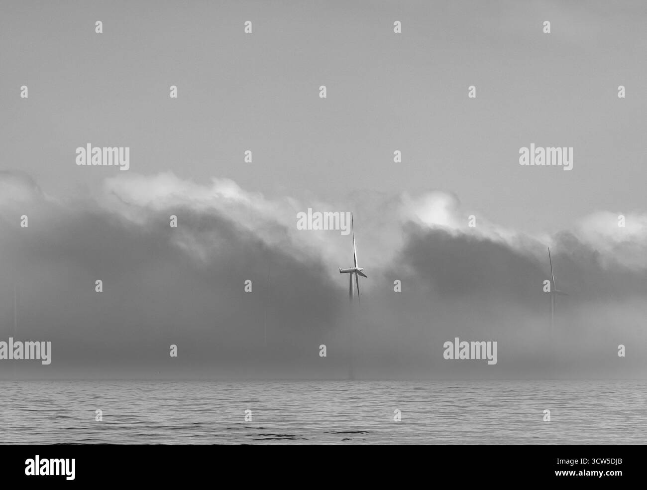Offshore wind turbines in sea mist in black and white Stock Photo - Alamy