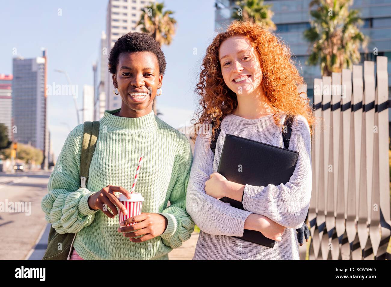 two young students smiling happy looking at camera Stock Photo
