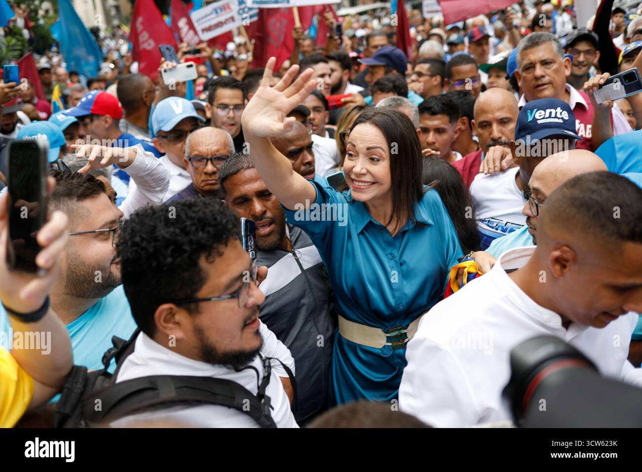 Caracas, Venezuela. 23rd June, 2023. Corina Machado (M) waves to ...