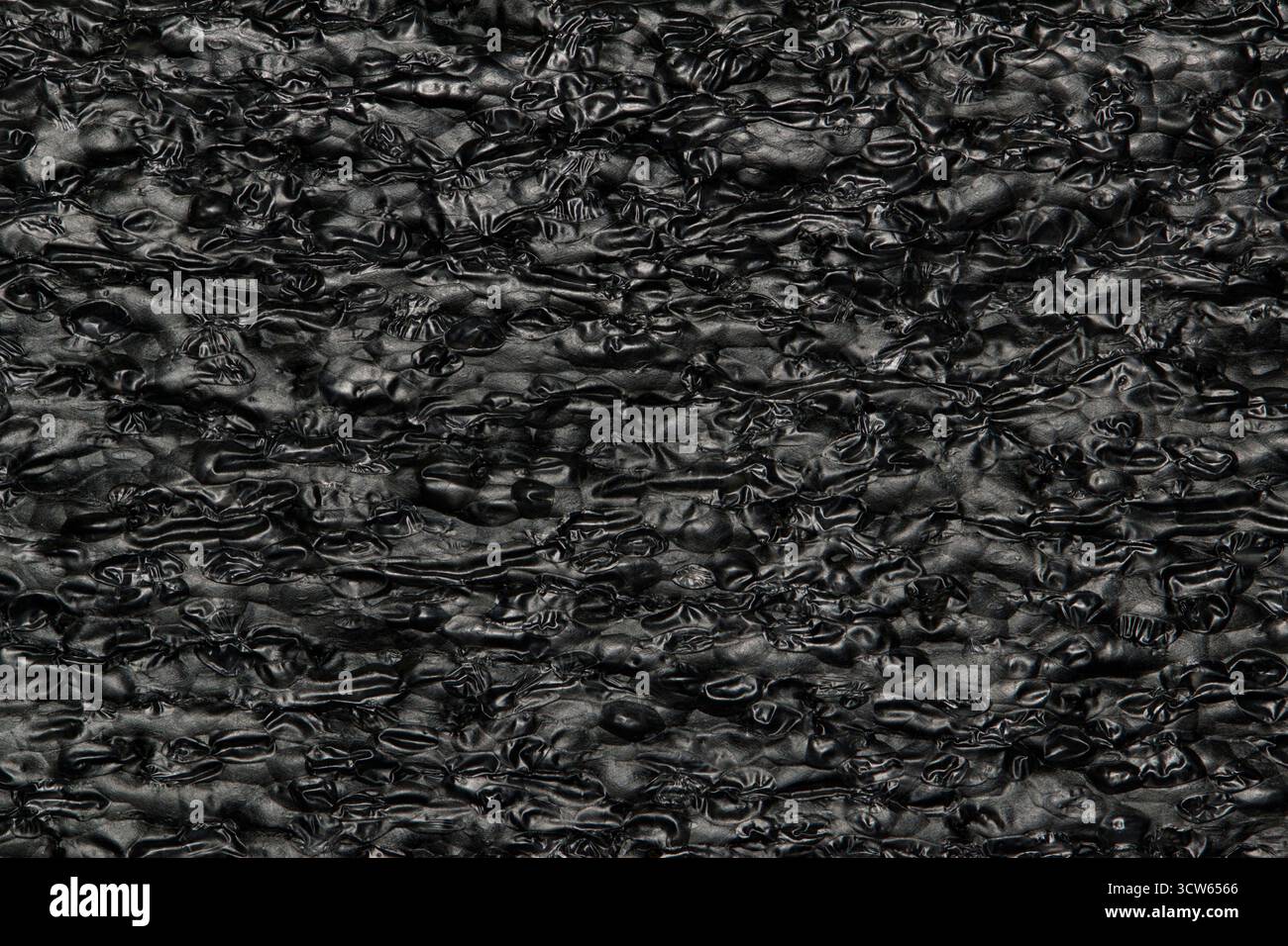 Tar black background expanded polyethylene foam sample EPE beads packing material textures. Stock Photo