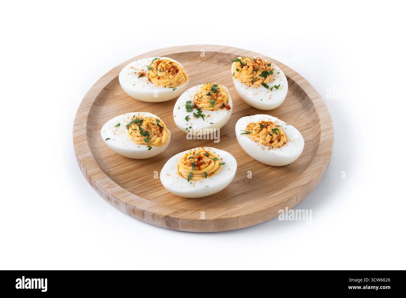 Homemade hard Boiled Deviled Eggs garnished with herbs isolated on white background. Stock Photo