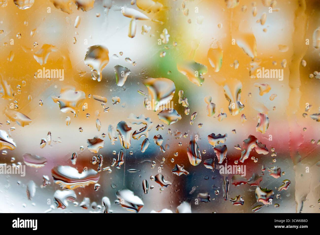 abstract background raindrops on glass. background of blurred urban landscape on a rainy day. wet window with bokeh effect Stock Photo