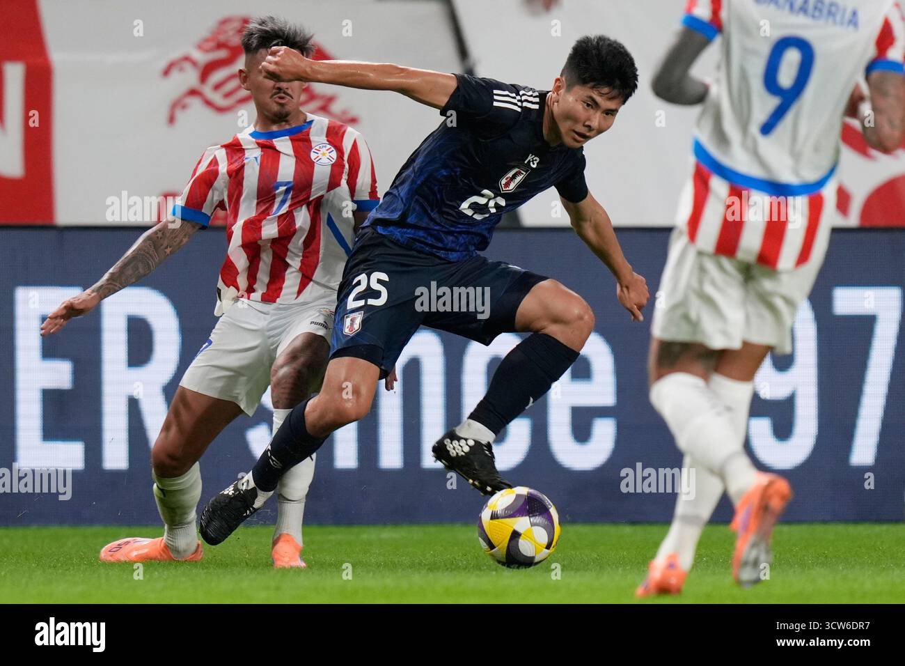 japan-s-junnosuke-suzuki-center-and-paraguay-s-diego-gonzalez-fight
