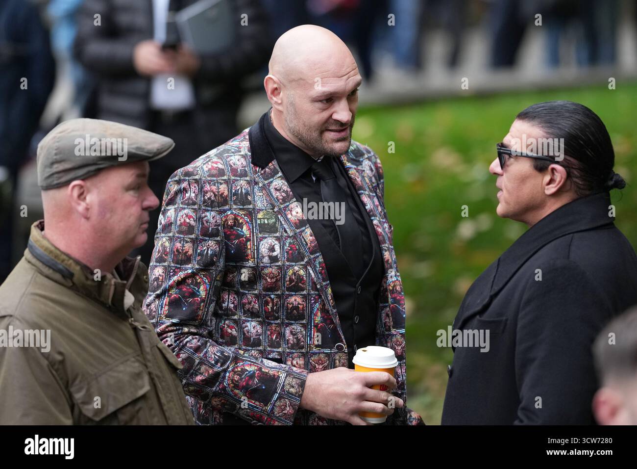 Boxer Tyson Fury, centre and actor Tamer Hassan attend the funeral of ...