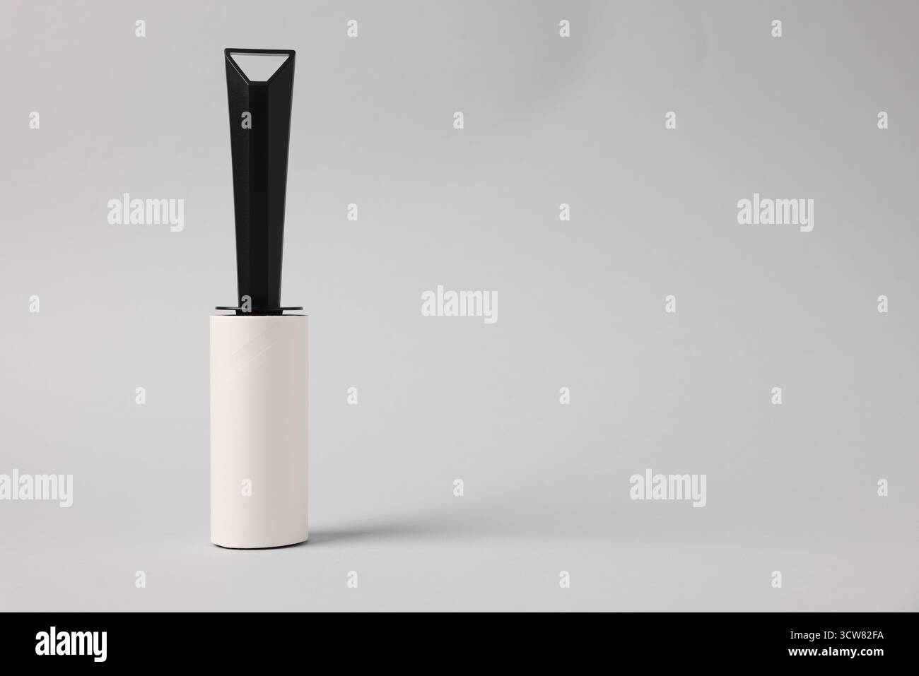 One lint roller on light grey background, space for text Stock Photo
