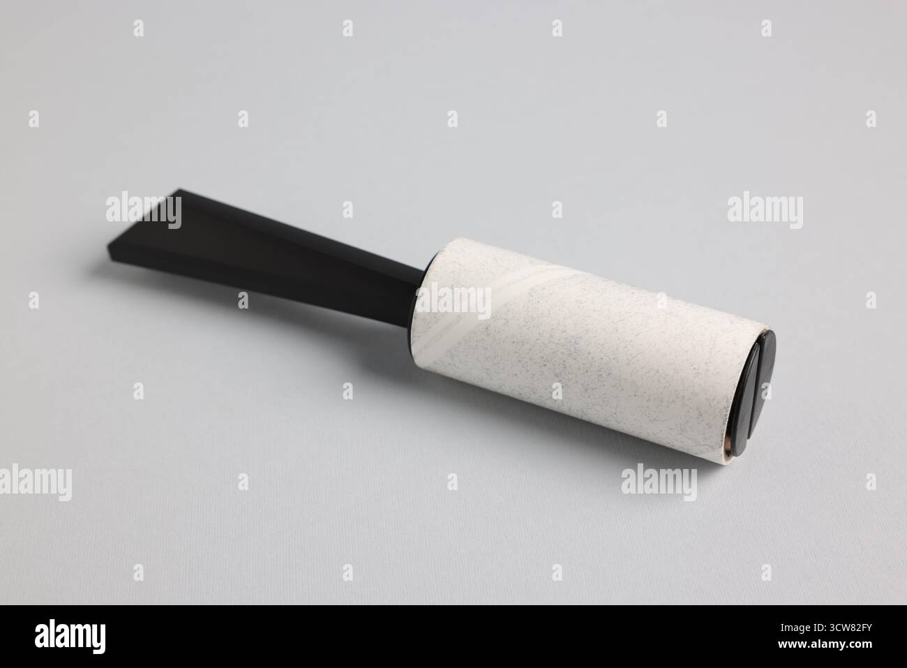 One lint roller on light grey background, closeup Stock Photo