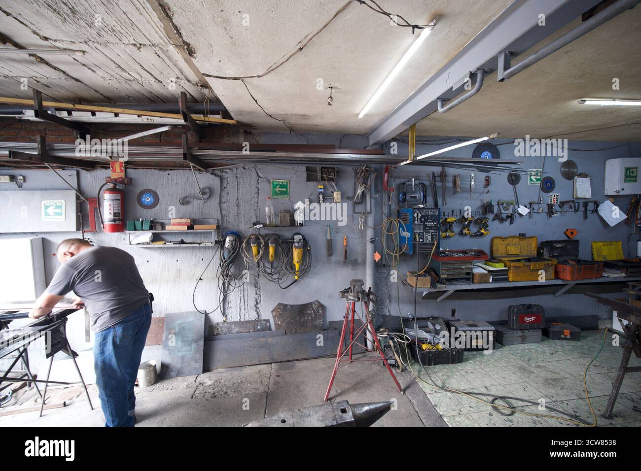 Metal workshop interior with tools, machinery and workers in Mexico Stock Photo