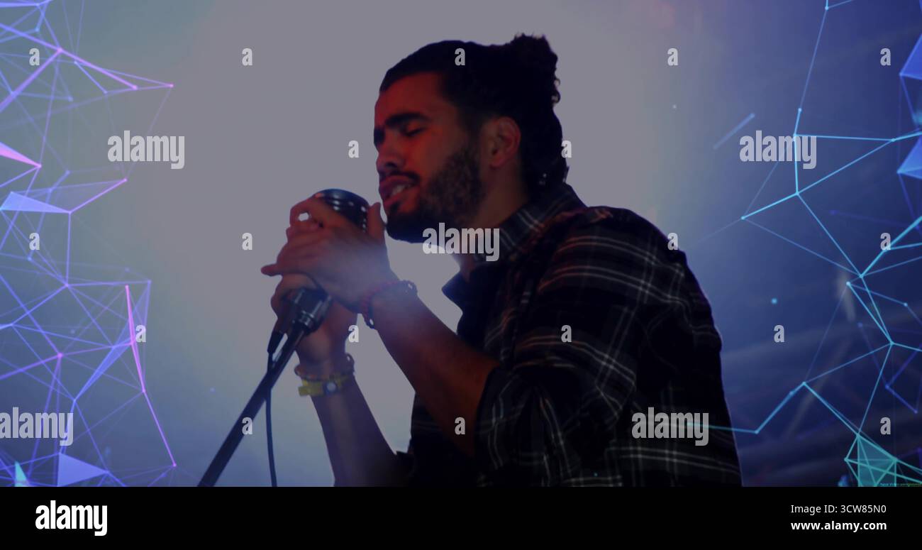 Male singer gripping mic singing hi-res stock photography and images ...