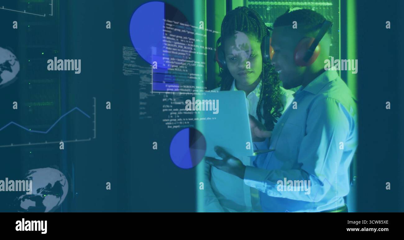 Collaborating IT professionals sharing code in server room with laptop, headset and data overlays. Technology, innovation, data visualization, teamwor Stock Photo