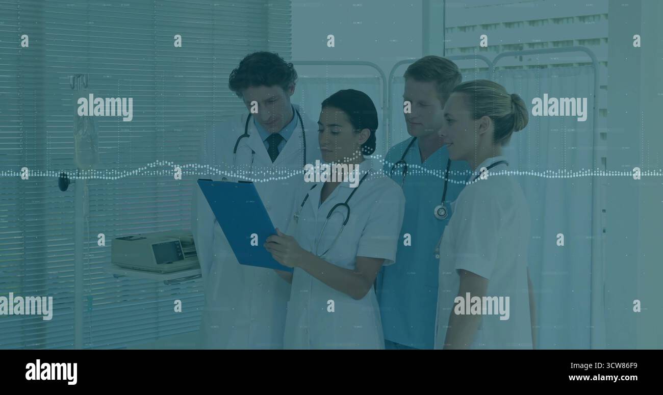 Reviewing patient notes medical team consulting at hospital ward, with ...