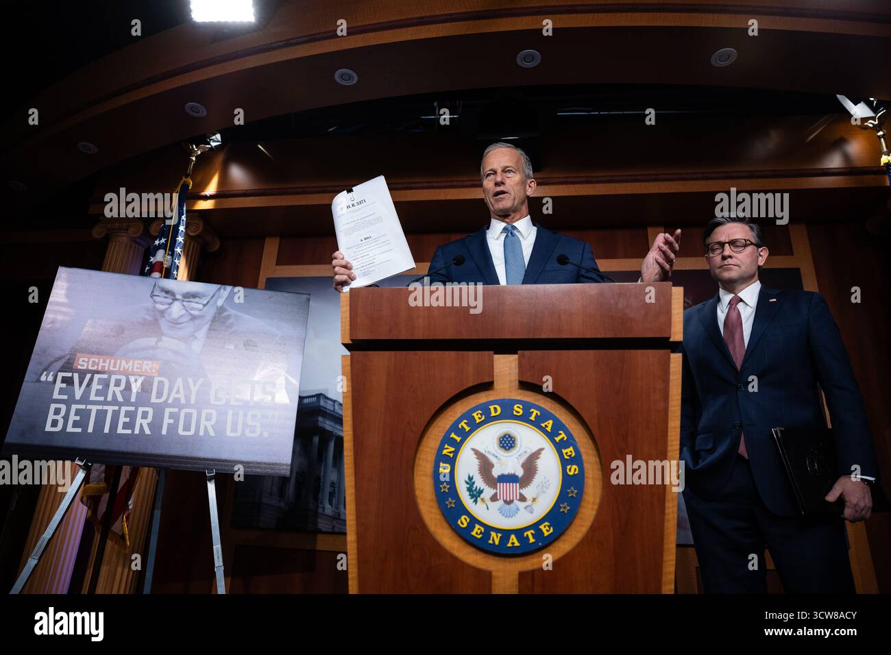 Senate Majority Leader John Thune (R-S.D.) holds a copy of a Republican ...