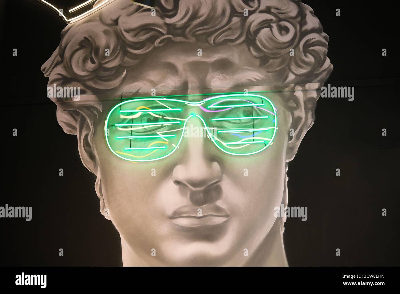Plaster sculpture with modern neon glasses Stock Photo