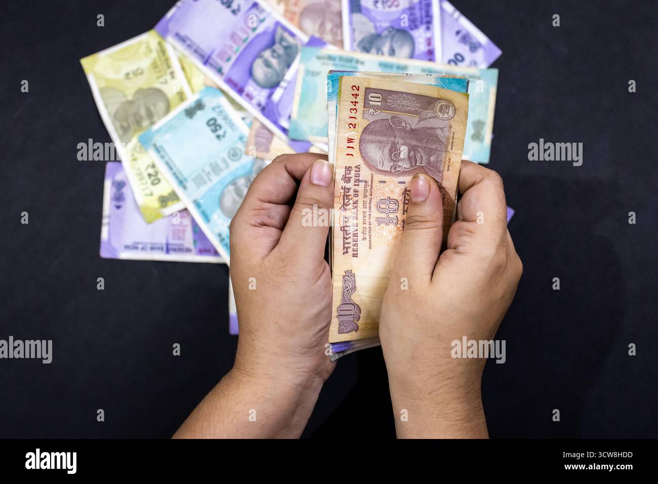 Indian rupee notes in hand, representing financial value and savings ...