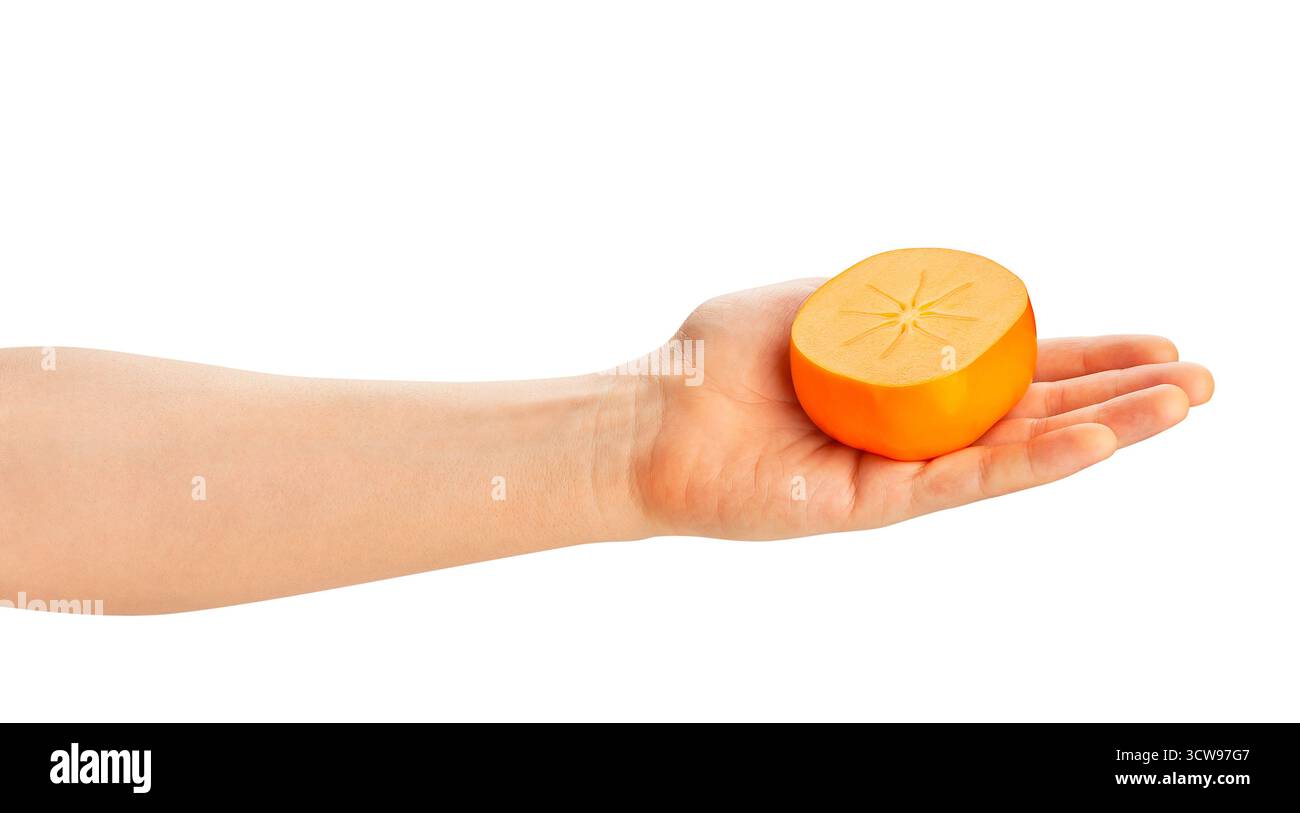 sliced persimmon in hand path isolated on white Stock Photo