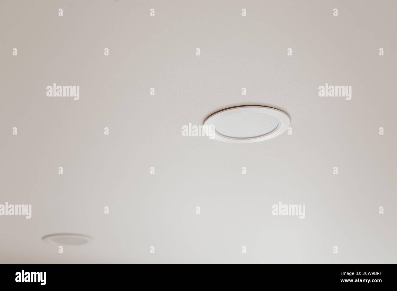 White stretch ceiling with spot lights in room Stock Photo