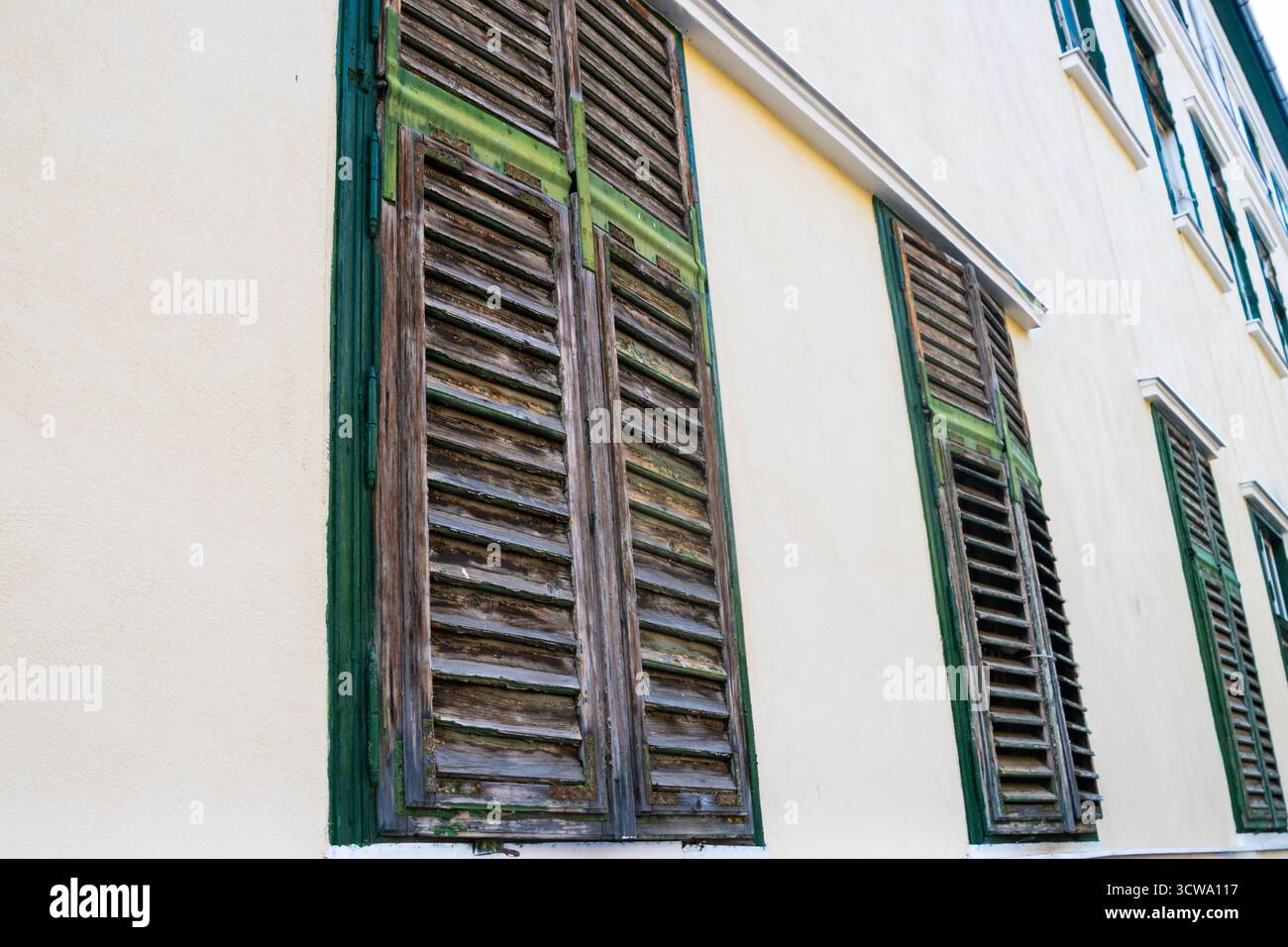 Exterior old wooden window blinds Stock Photo