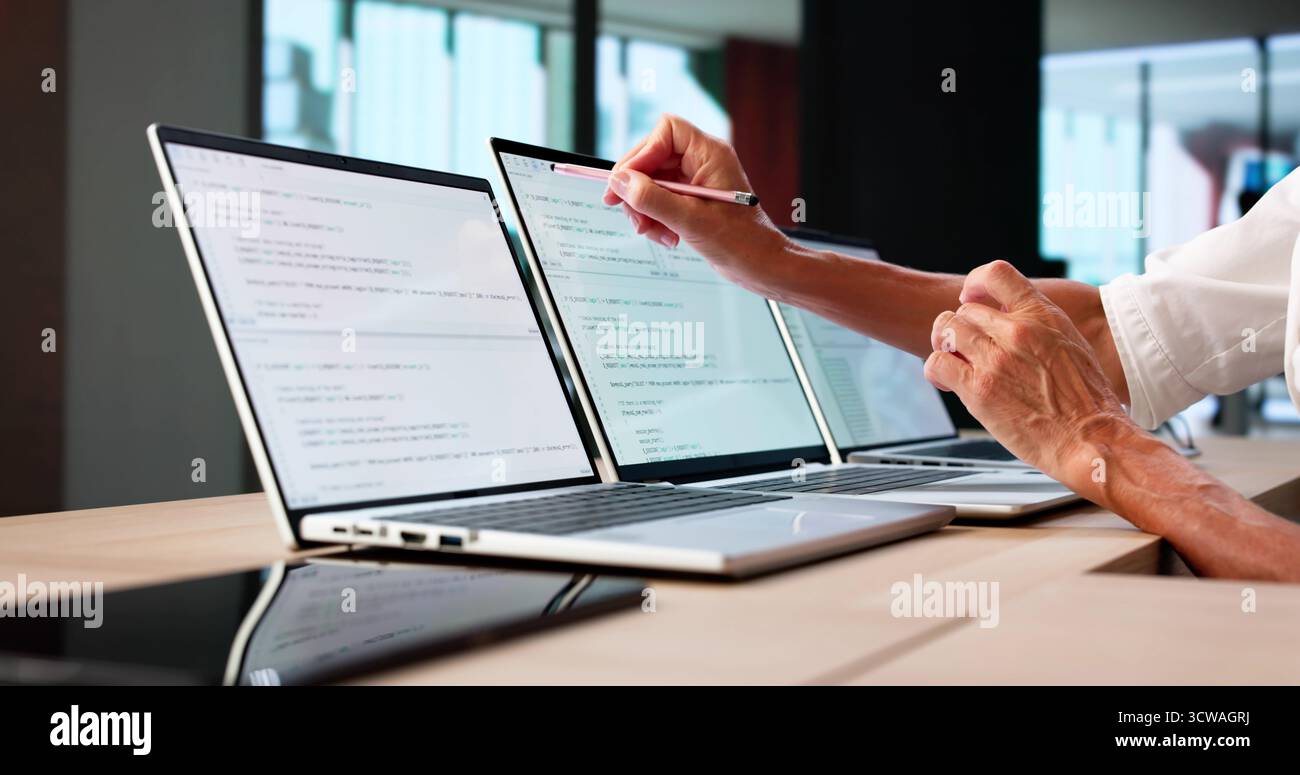 Developer Office: Coding And Developing Software On Computer Screens Stock Photo
