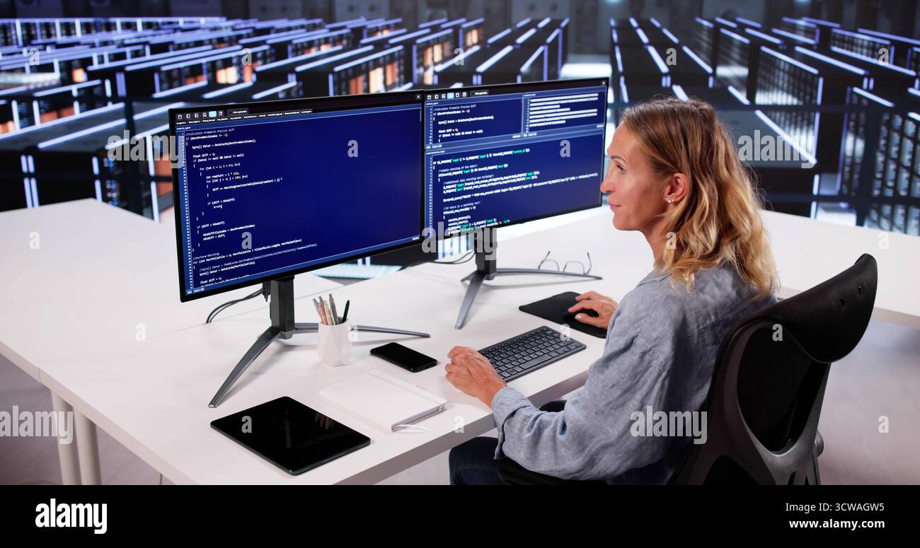 Cloud Computer Engineer Coding In Server Room In Data Center. Configuring AI Technology Stock Photo