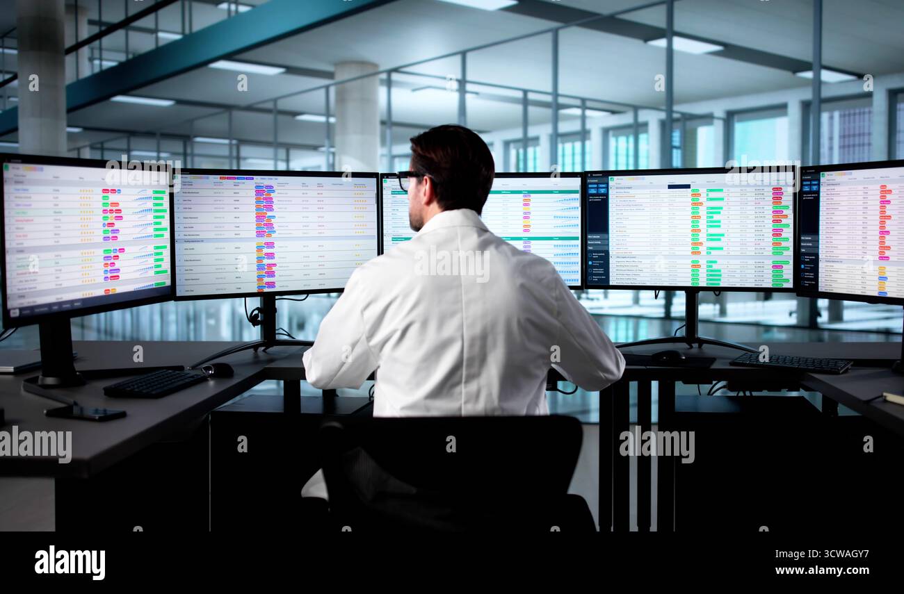 Doctor Updates Hospital Spreadsheet Using Computer Codes For Medical Billing. Stock Photo