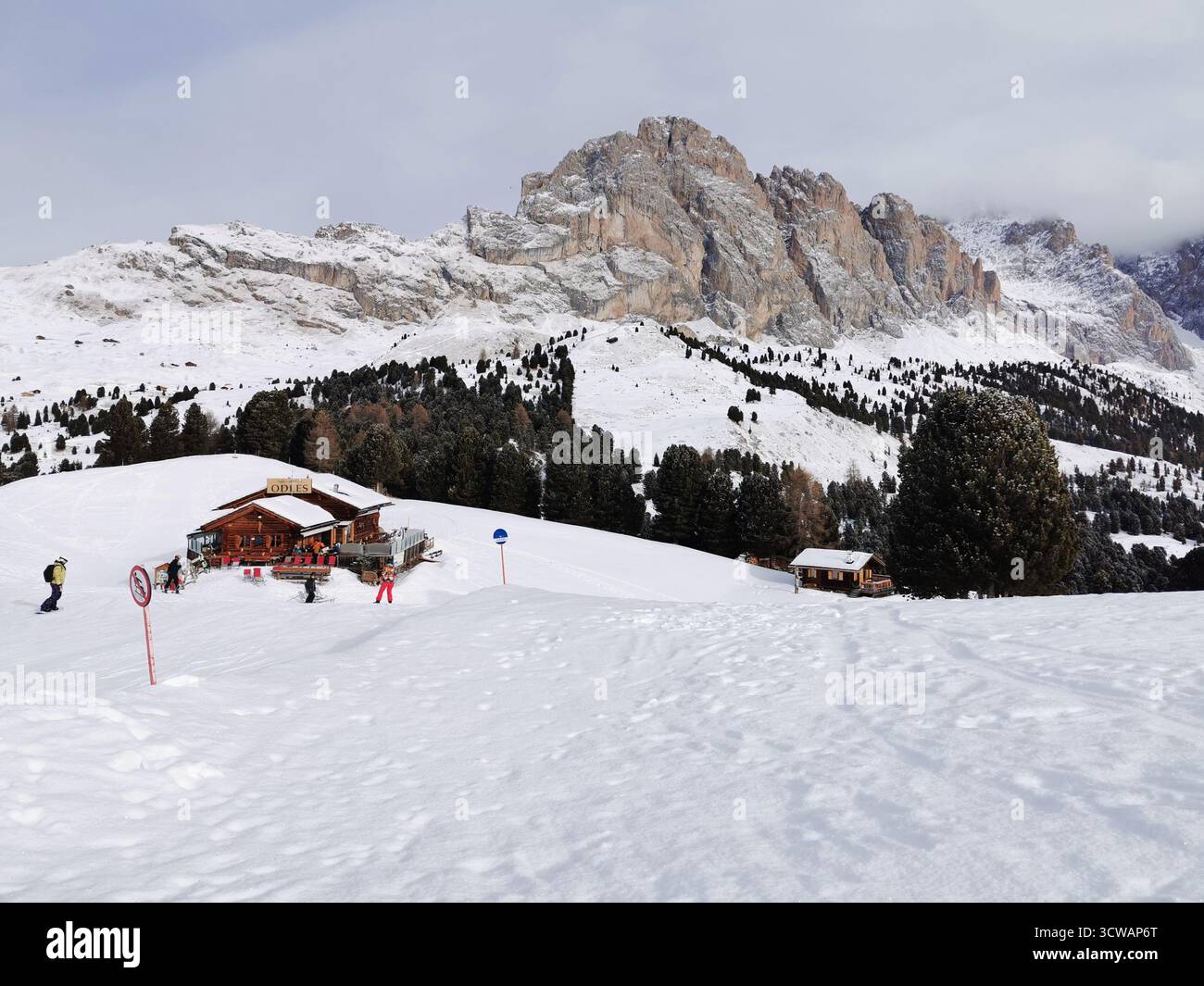 Skiers descend Col Raiser’s blue run in the Dolomites, with Grosse Fermeda and Odles Hut during the ski season - part of the Sellaronda in Val Gardena. - Smartphone Captured Stock Image