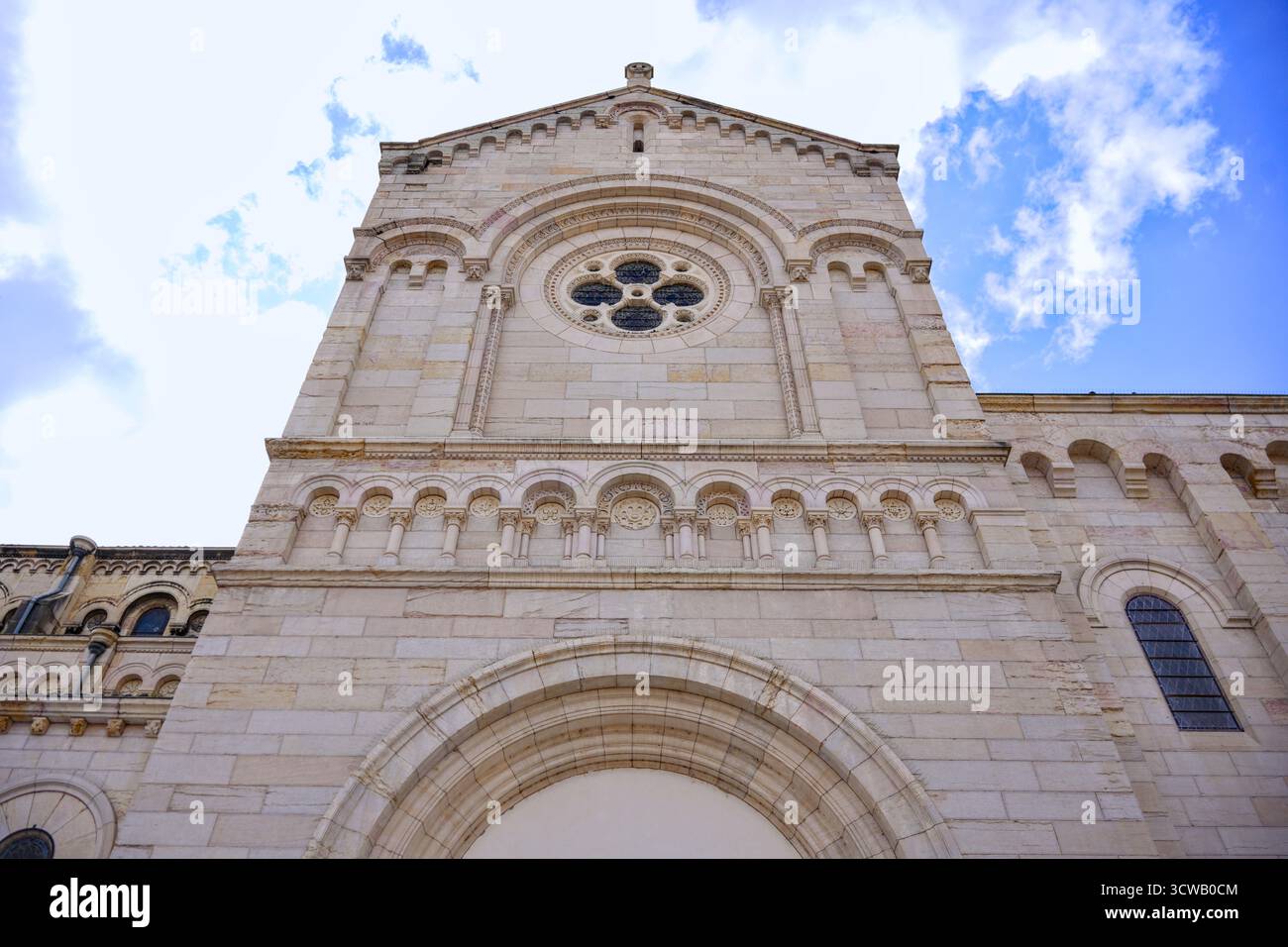 Historic stone cathedral facade under blue sky Stock Photo - Alamy
