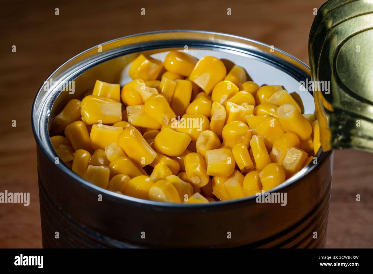 Canned pickled corn, close up. The open can with sweet corn Stock Photo