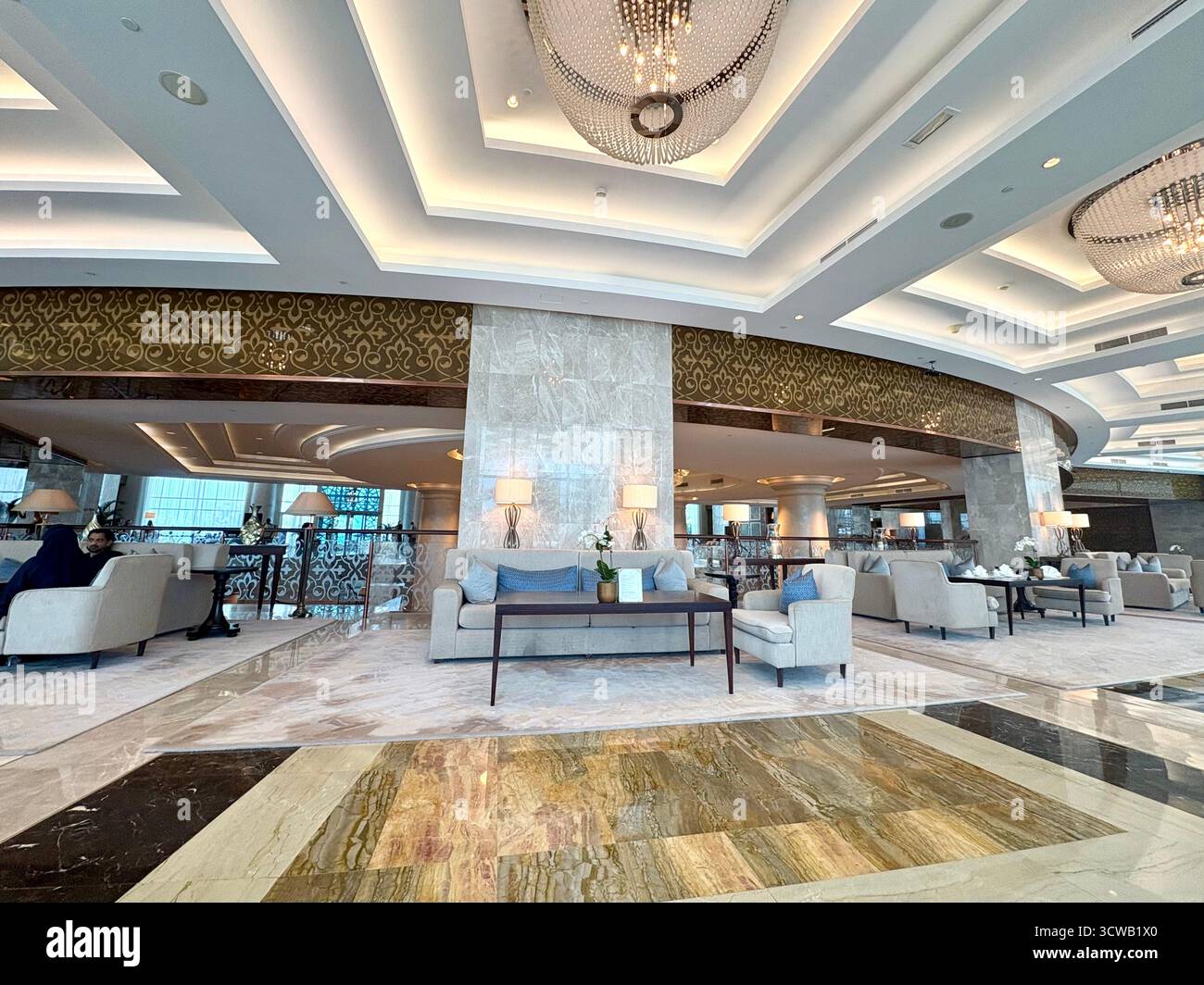 Dubai hotel lobby foyer interior at the Waldorf Astoria hotel, sofas and chairs provided for guests to use and relax amongst 5 star luxury furnishings - Smartphone Captured Stock Image