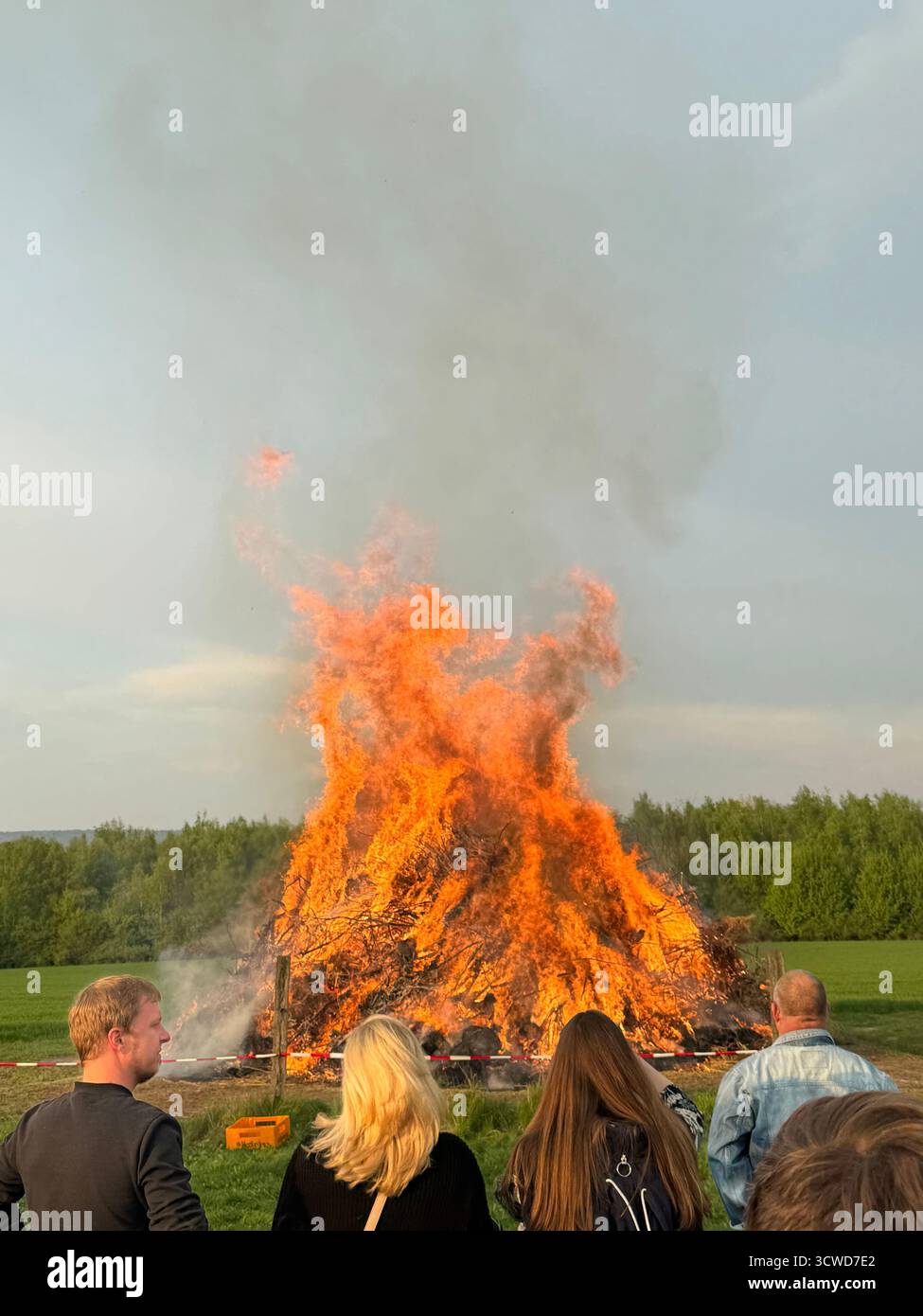 Bonfire burning in a grassy field - Smartphone Captured Stock Image