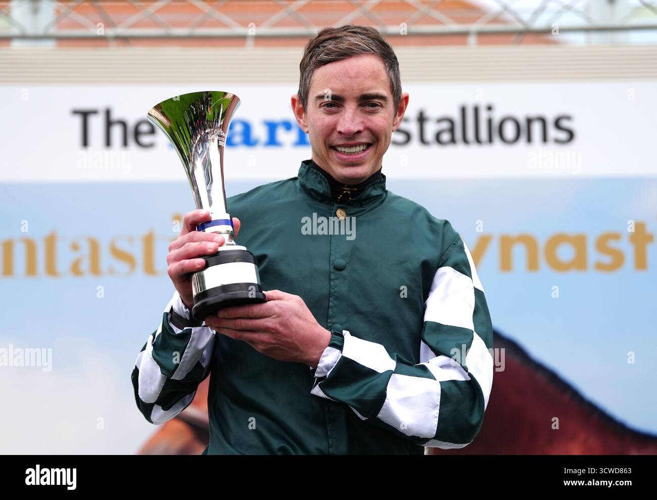 James Doyle celebrates with the trophy after winning the Darley ...